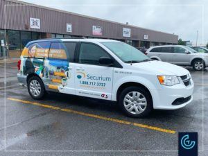 Partial vehicle wrap and lettering on the van 2019 Dodge Grand Caravan for the security service provider Securium