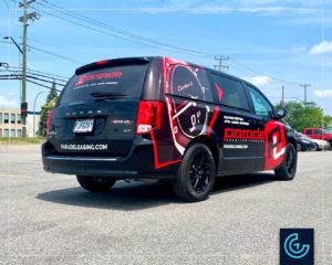 Partial vehicle wrap and lettering on a black minivan 2020 Dodge Caravan for the vehicle leasing company Parade Leasing