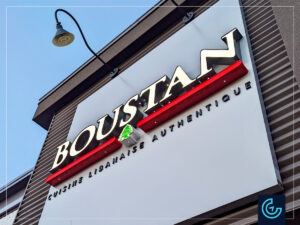 Illuminated storefront sign in acrylic channel letters for the restaurant Boustan in St-Eustache.