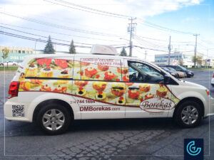 Food caterer minivan lettering on a 2013 Dodge Caravan for DM Bokeras.