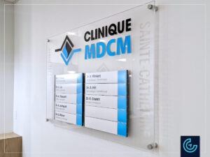 Custom directory sign in clear acrylic, frosted background and aluminium frames with changeable contents for the new wing of MDCM Clinic in Sainte-Catherine.