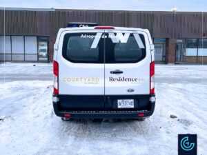 Branding shuttle van lettering on a 2023 Ford Transit Passenger Low Roof for the Marriot hotel of Montreal Airport.