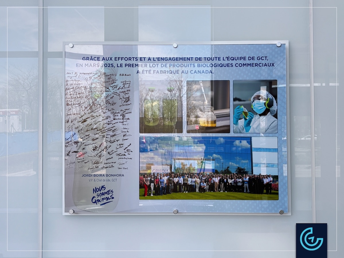 Custom milestone achievement display with custom mounts on glass wall designed, printed and installed for the international pharmaceutical company Grifols in Montreal.