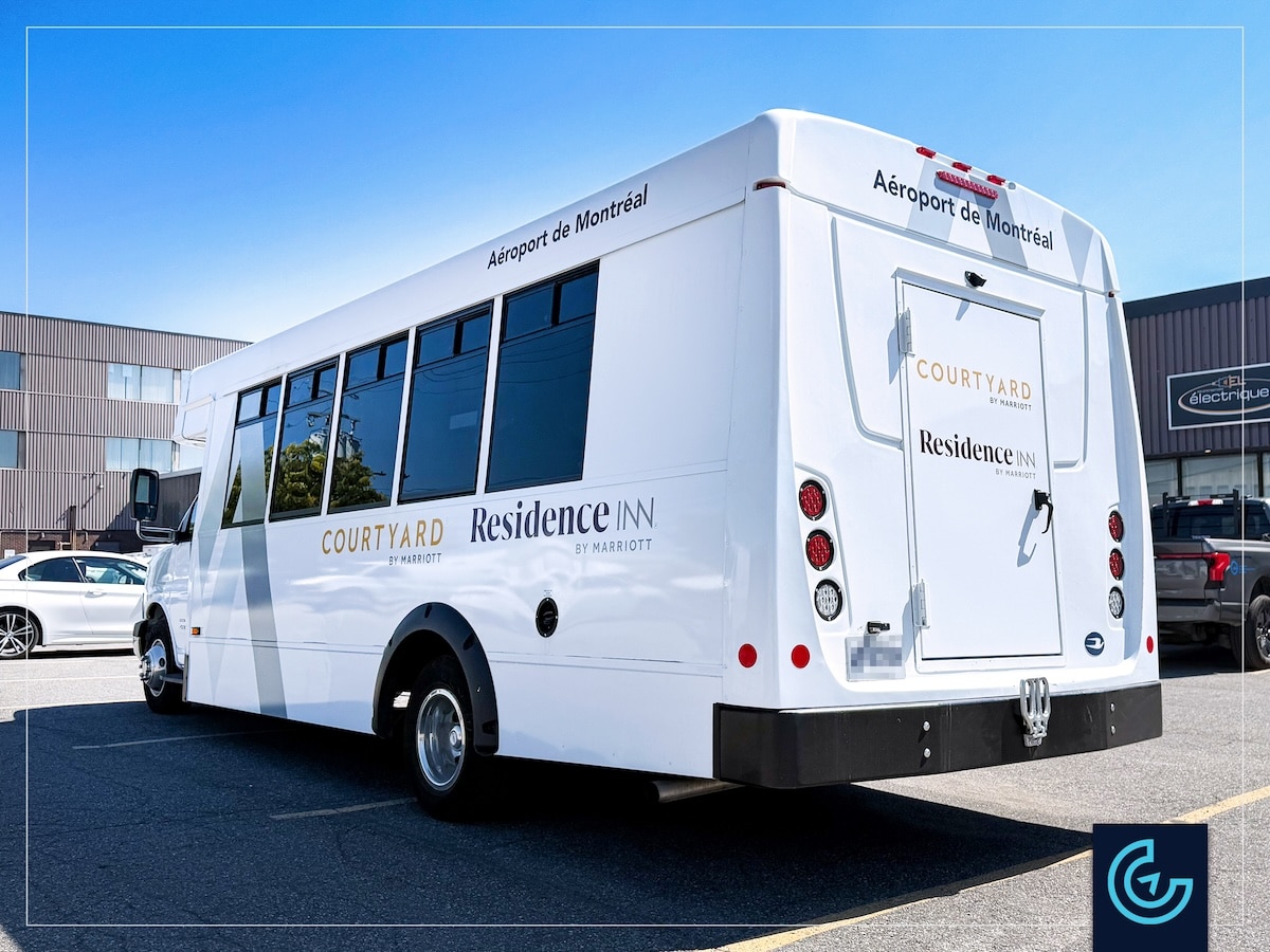 Shuttle bus lettering on a 26-seat bus body for the Montreal Airport Marriott In-Terminal Hotel.