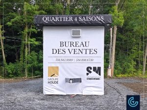 Custom wood trailer wrap in matte vinyl banners for the “Sales office” of the new residential housing project Quartier 4 Saisons by the construction company Groupe Houde.