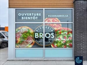 Temporary hoarding-style window graphics “Opening soon” designed, printed and installed for the new store of the pizza restaurant franchise Pizzeria Bros in Beloeil.